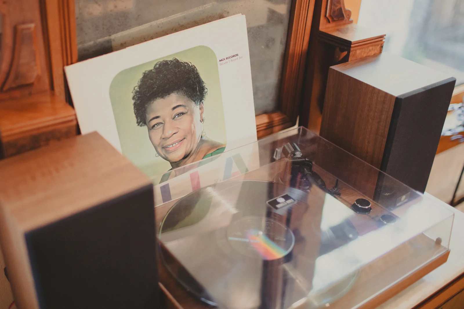 An Ella Fitzgerald record being organized beside a turntable